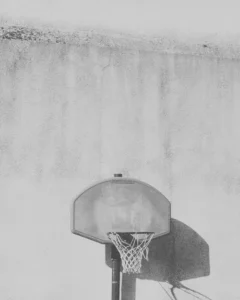 Empty basketball hoop mounted on an outdoor court.