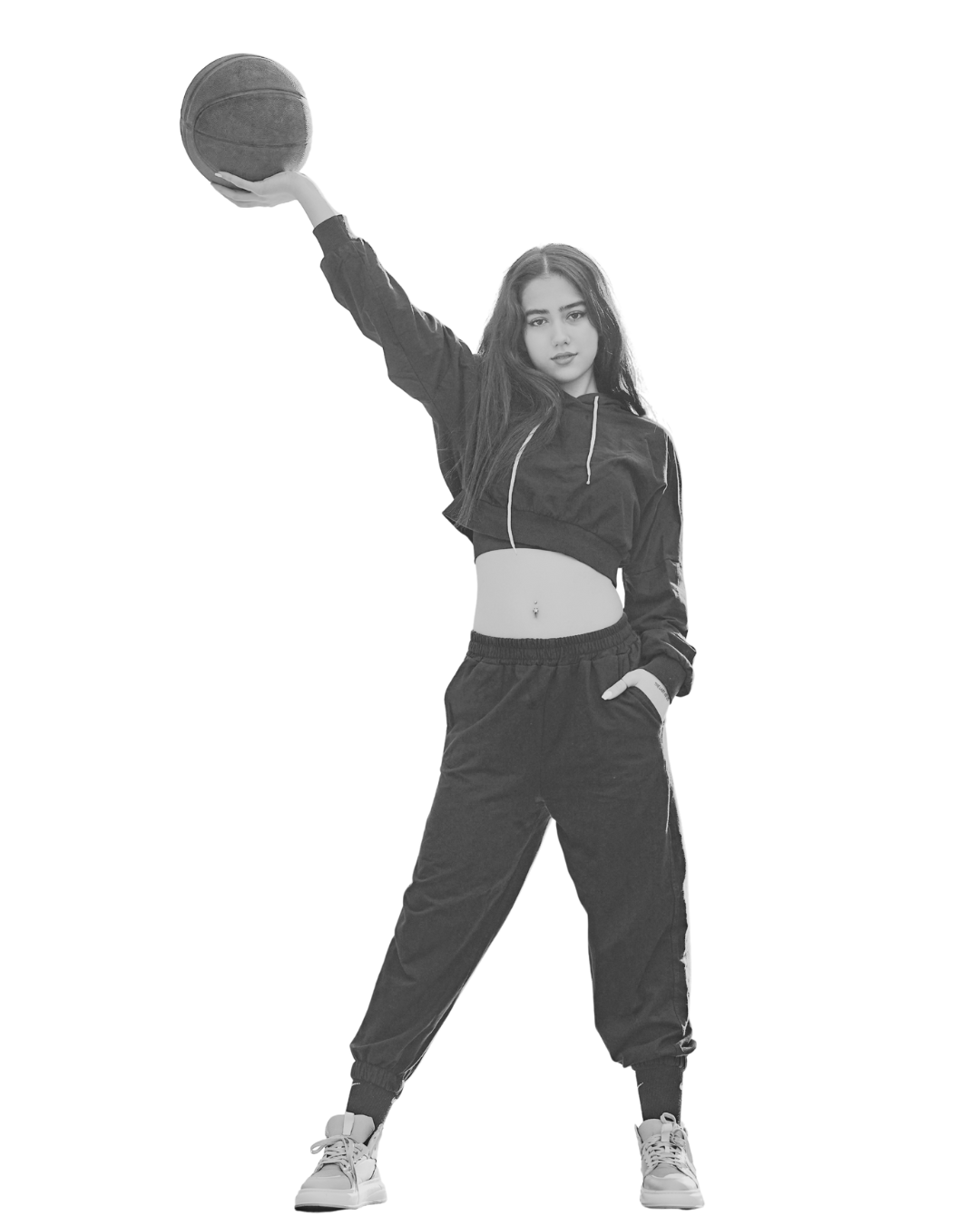 Person standing confidently while holding a basketball overhead.