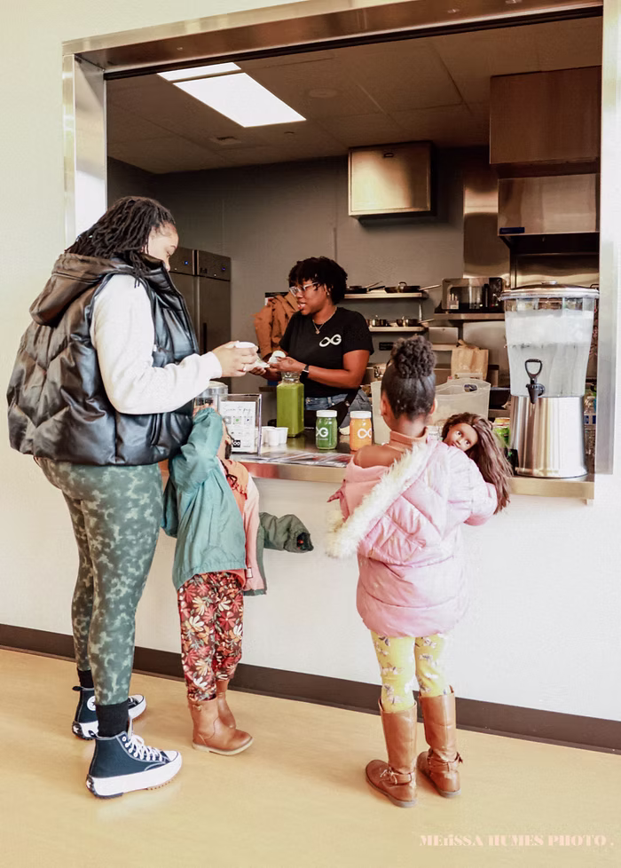 Families visiting a food service station hosted by local Black-owned businesses during the Fircrest Black History Month celebration.