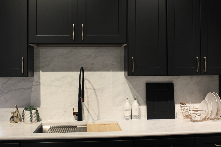 Close up image of kitchen counter, with black iron shaker cabinets