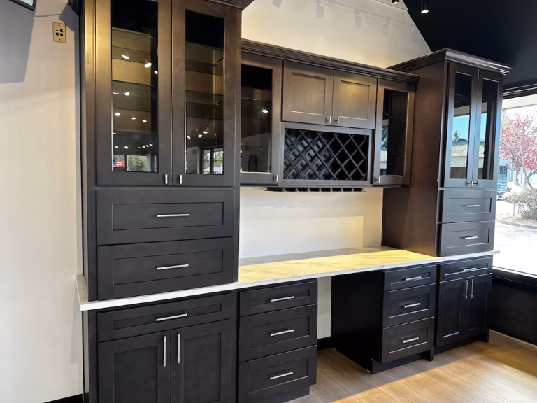 Custom black cabinetry with built-in wine storage and workstation for a sophisticated home office or kitchen nook.