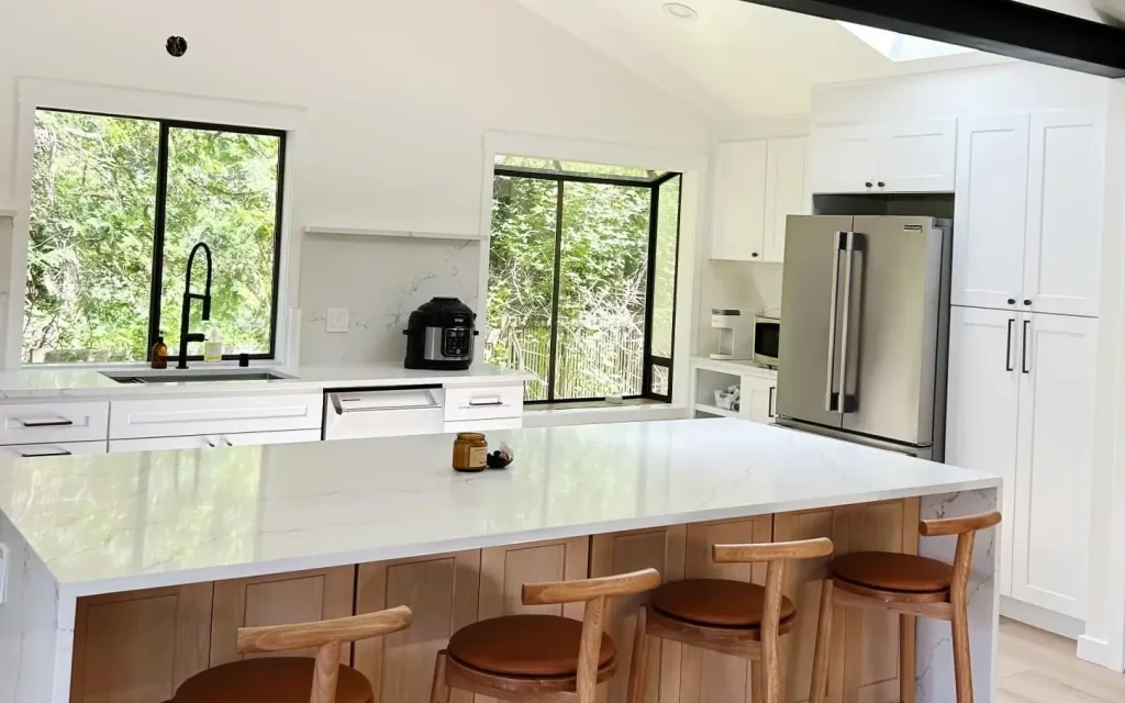 Minimalist kitchen design in Edmonds, WA with flat-panel cabinetry, under-shelf lighting, and integrated modern appliances.