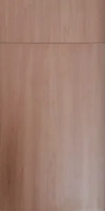 Frameless cabinet door in warm cherry wood finish with subtle vertical grain.