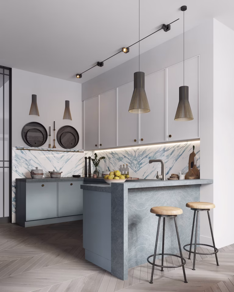 Two-tone kitchen with light upper slim shaker cabinets and blue base cabinetry featuring a bold marble backsplash