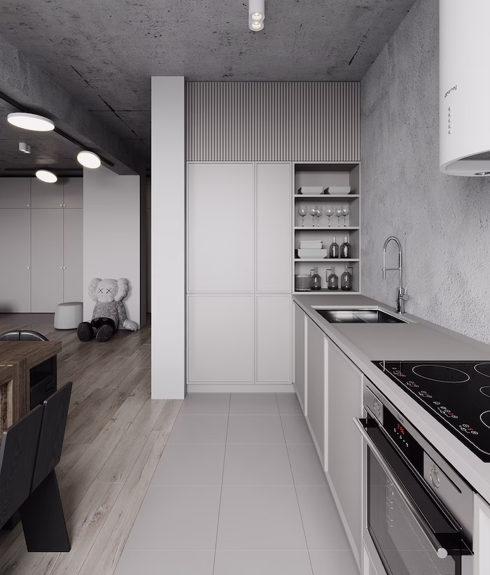 Streamlined gray slim shaker kitchen cabinets paired with high-contrast marble counters and built-in appliances