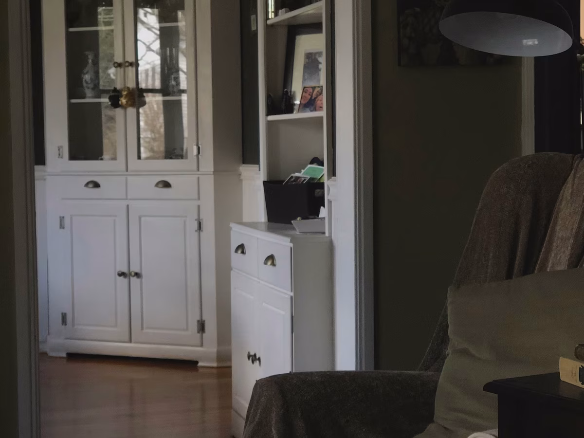 Cozy home remodel with white shaker cabinets next to an armchair.