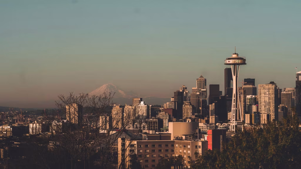 Seattle skyline with Space Needle and Mount Rainier in the background at sunset – displaying the areas we serve across the Greater Seattle region