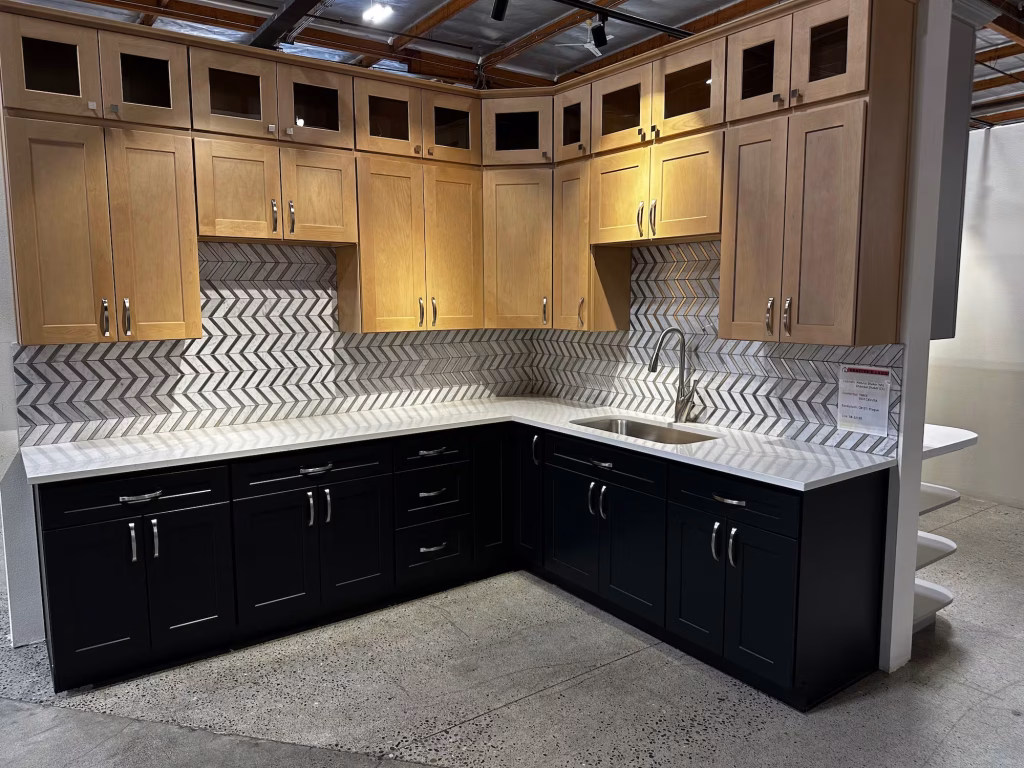 Two-tone kitchen design with wood and navy cabinets and chevron tile backsplash from Iconic Cabinetry