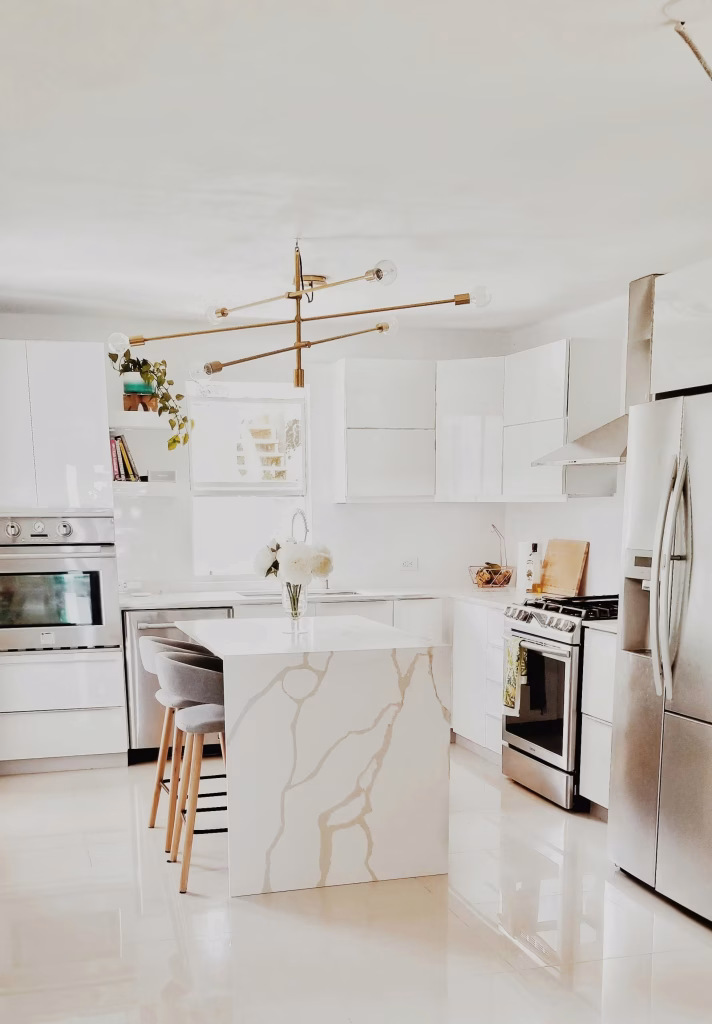 Bright kitchen remodel featuring white cabinetry, tile backsplash, and bright tile flooring in a Seattle-area home