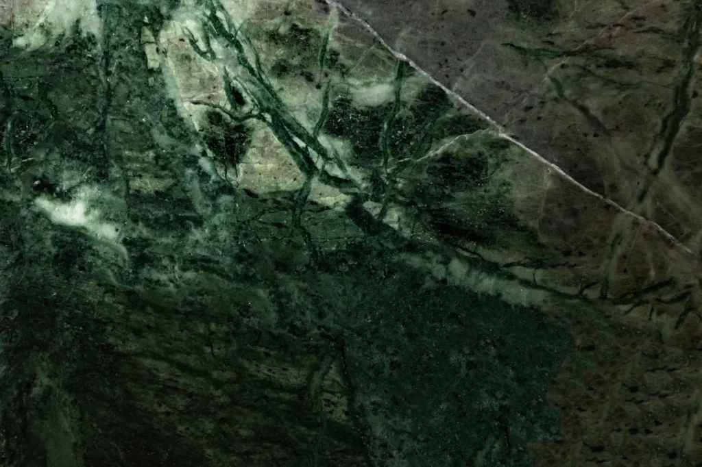 Close-up of green quartzite stone countertop with dramatic veining, a trending kitchen material in 2026