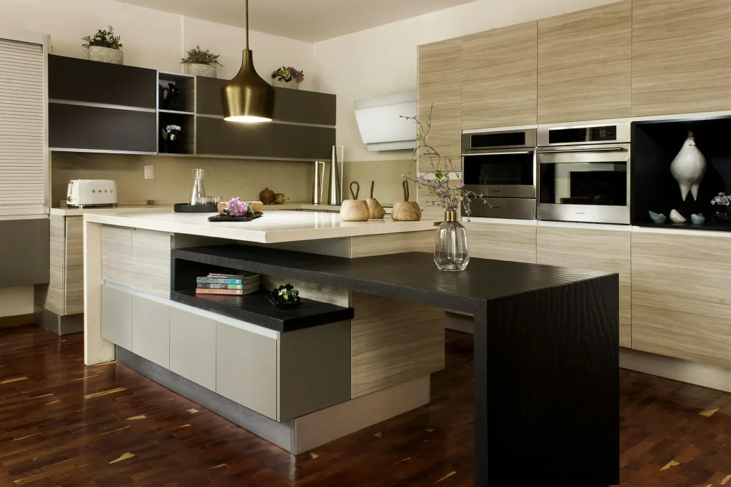 Contemporary kitchen with tonal wood slab cabinets and two-tone countertops, a top design trend for 2026