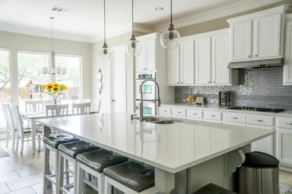 Bright white shaker kitchen with natural lighting and textured finishes, showing how white can still work in 2026 when balanced well